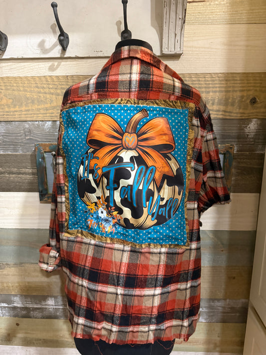 Plaid flannel with a colorful patch featuring a bow and cow print design.